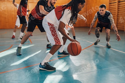Preview: Interracial sportsman dribbling a ball on basketball training.