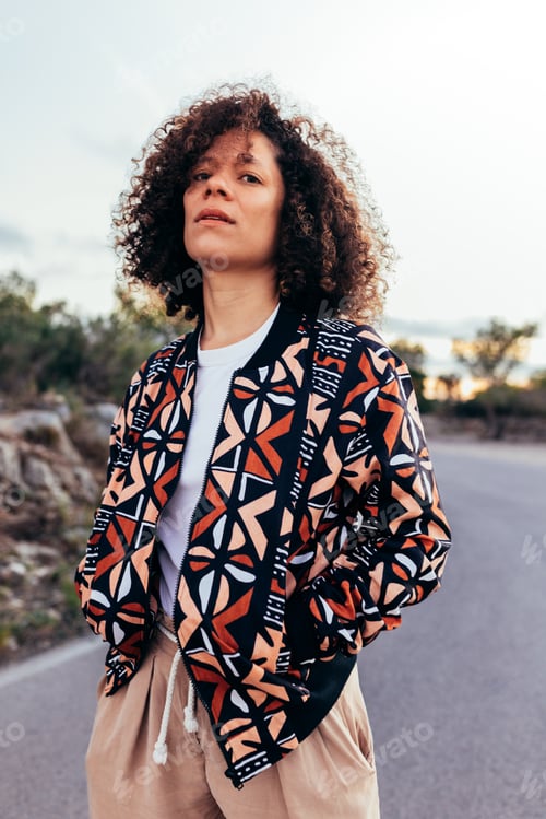 Preview: Stylish ethnic woman standing on street