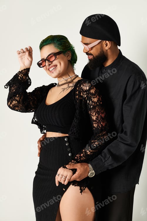 Preview: Stylish couple in sunglasses sharing a joyful moment in a studio setting
