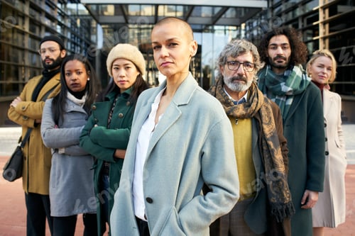 Aperçu: A group of serious business people from a company led by an empowered shaved air woman