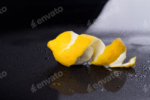 Preview: Peeled lemon on wet surface.