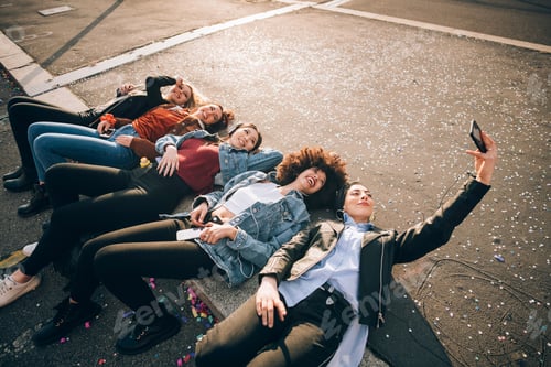 Preview: Friends together on kerb taking selfie and using smartphones, Milan, Italy