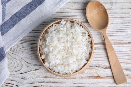 Preview: Bowl with tasty cooked rice on white wooden table, flat lay