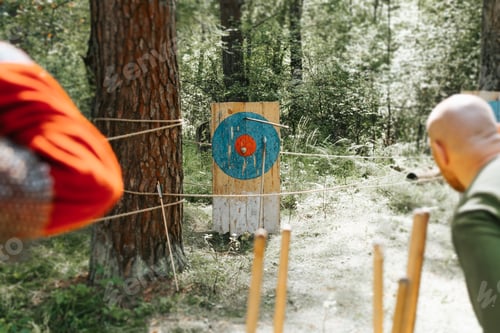 Preview: Close-up of medieval soldiers competing in marksmanship, throwing spear at target in open air.