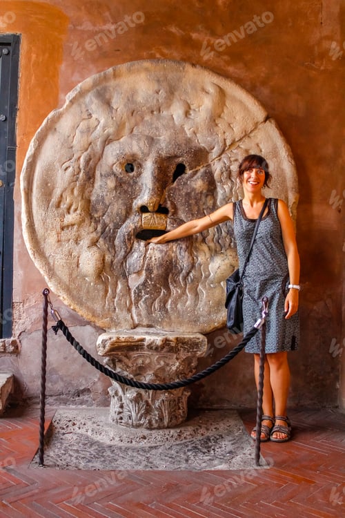 Preview: A young tourist in the famous Bocca de la Verita in Rome. Italy