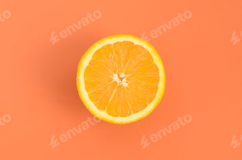 Preview: Top view of a one orange fruit slice on bright background in orange color. A saturated citrus te
