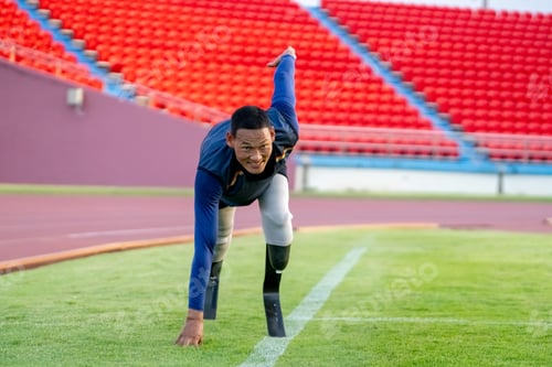 Preview: Asian para-athletes with prosthetic blades sprint on a running track at stadium.