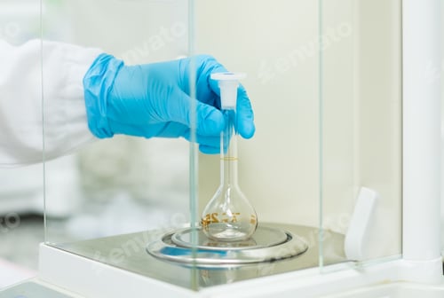 Preview: The operator is weighing the empty volumetric flask on analytical balance for glassware calibration