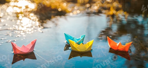 Preview: Multicolored paper boats. Colorful pink yellow blue orange ships in big spring snow puddle on