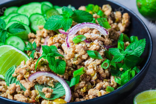 Preview: Thai chicken salad larb gai with onion, cucumber and mint. Asian food concept.