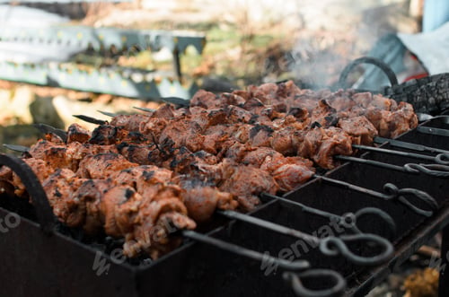 Preview: Outside charcoal grilling of meat. Barbecue cooking, fragrant smoke, selective focus. Concept picnic