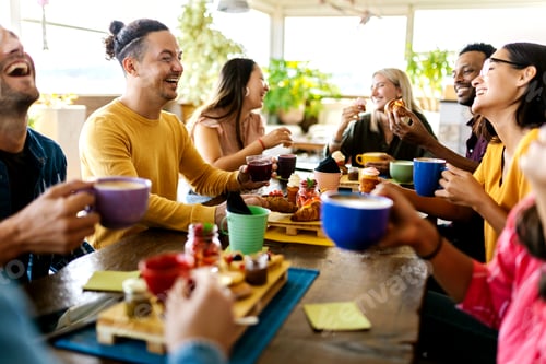 Preview: Smiling group of diverse friends having breakfast