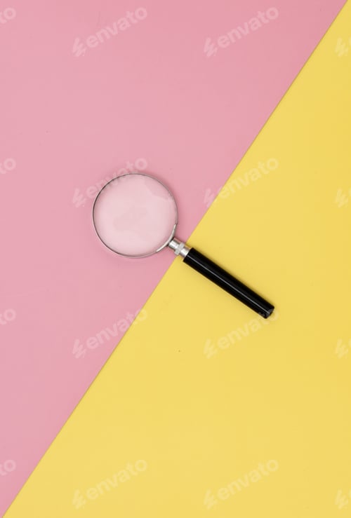 Preview: magnifying glass on yellow and pink backgrounds.