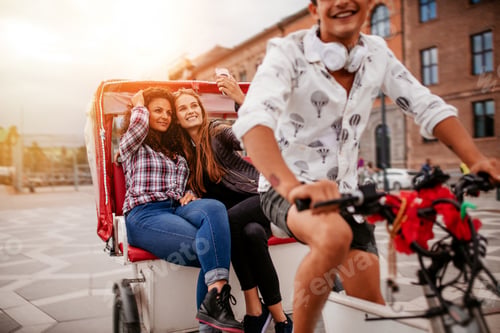 Preview: Female friends taking selfie on tricycle