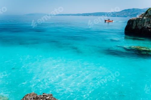Preview: Small red boat floating on clear blue sea water. Summer beach vacation relaxation concept