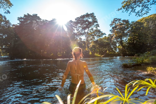 Preview: A young woman bathing in the Pulhapanzak waterfall on Lake Yojoa. Honduras