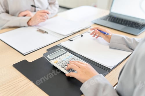 Preview: Business woman calculating an estimate