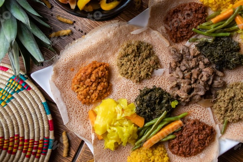 Preview: High angle shot of the ingredients of traditional Ethiopian food on loaves of bread