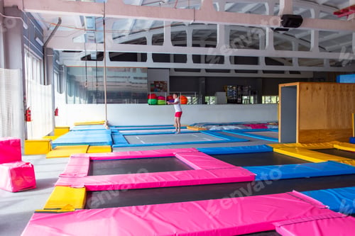 Preview: Fitness, fun, leisure and sport activity concept - Handsome happy man jumping on a trampoline