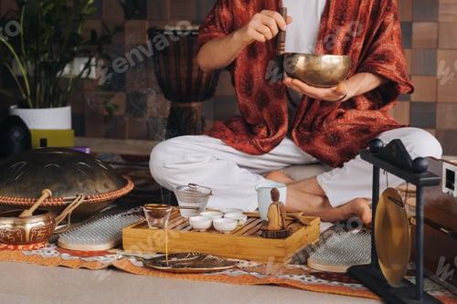 Preview: Tibetan singing bowl in the hands of a man during a tea ceremony