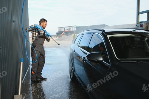 Preview: Man worker washing car service. Car wash cleaning station high pressure water.