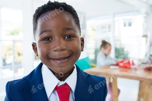 Preview: Boy as business executive smiling while standing in office