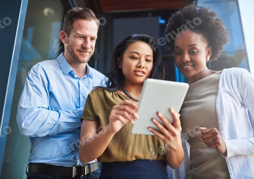 Preview: Cropped shot of a group of businesspeople using a digital tablet while standing on a balcony