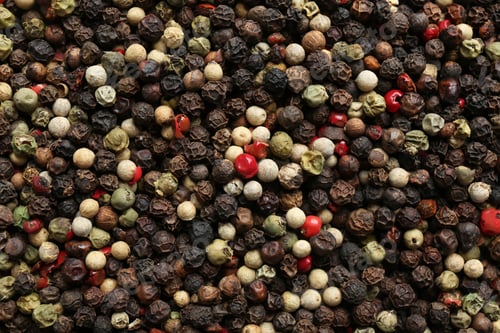 Preview: Many different peppercorns as background, top view