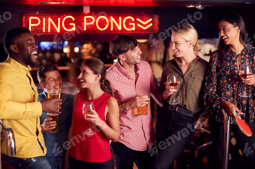 Preview: Male And Female Friends Meeting For Drinks And Socializing In Bar After Work