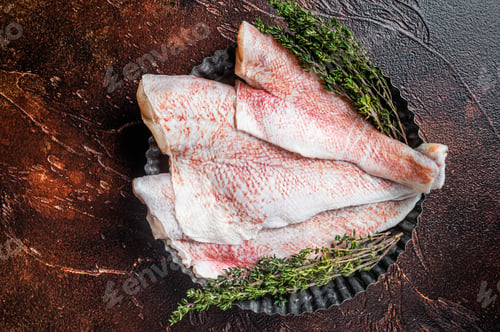 Preview: Raw ocean red perch fillet, Snapper fish with herbs. Dark background. Top view
