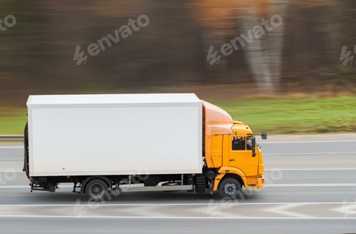 Preview: Yellow heavy truck driving on the highway