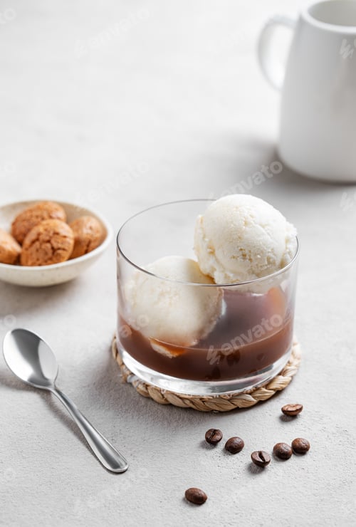 Preview: Affogato coffee with vanilla ice cream scoops and espresso in a glass on a light background