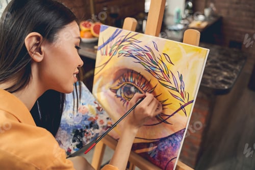 Preview: Beautiful female artist drawing picture with paints