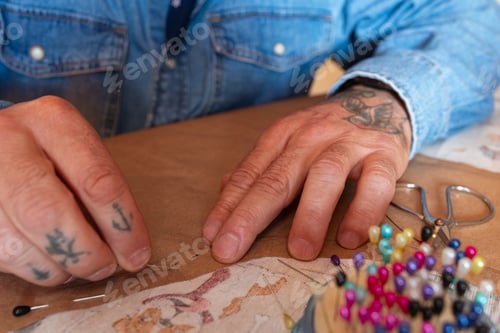 Preview: Close-up of a designer's hands making from a pattern