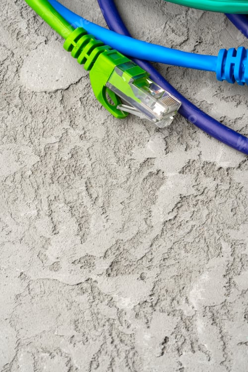 Preview: Colored network cable patch-cord on gray textured background