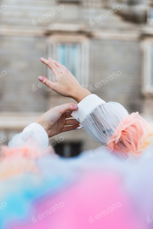 Preview: Crop hands of street artist adjusting sleeves