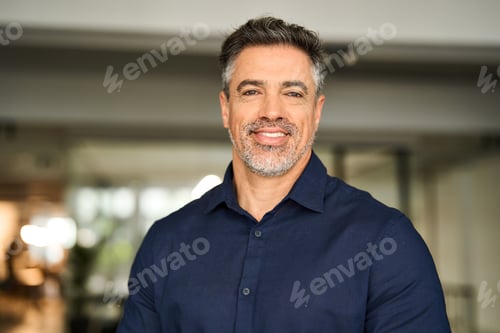 Preview: Headshot portrait of happy mature professional business man standing in office.
