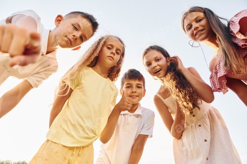 Preview: View from below of group of kids that looking down and having fun