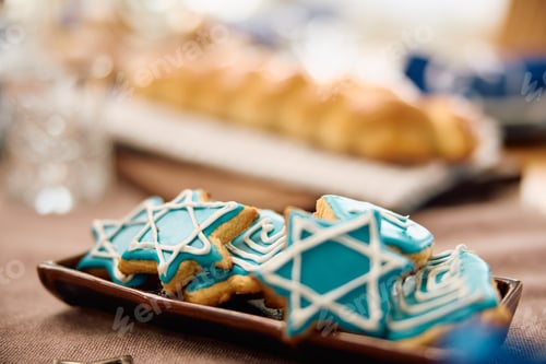 Preview: Cookies with star of David on the table during Hanukkah celebration.