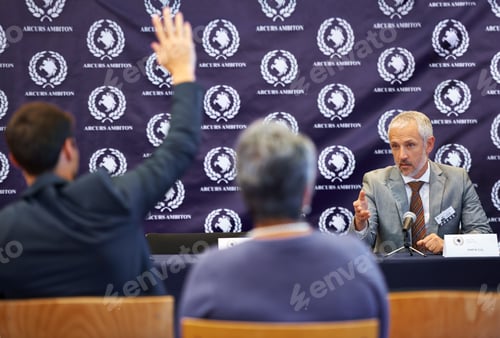 Preview: You sir, what is your question. Shot of a group of businesspeople in a press conference.