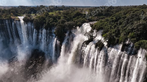 Preview: Majestic Kalandula Waterfall cascading in Angola\'s lush landscape during daytime