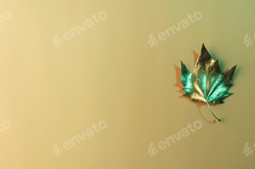 Preview: Metallic gold autumn leaf with copy space on orange background