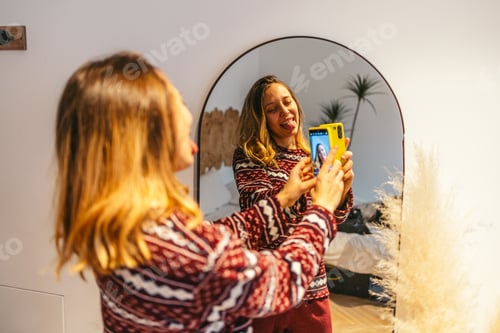 Preview: Young woman waking up and taking a selfie in front of mirror