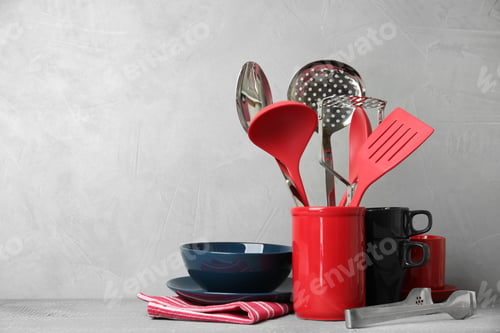 Preview: Different kitchen utensils on wooden table against light grey background. Space for text
