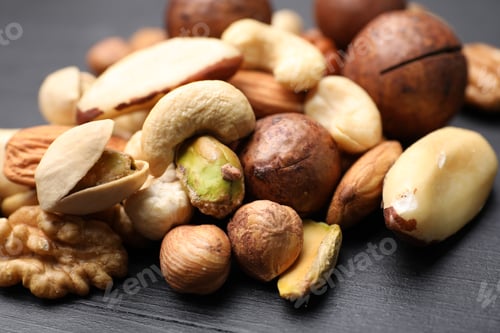 Preview: Mix of different nuts on black wooden table, closeup