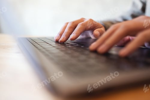 Preview: Closeup image of a woman working and typing on laptop computer keyboard on the table