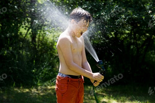 Preview: Boy playing with garden hose