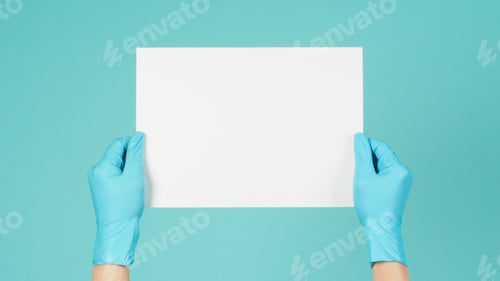 Preview: Hands wear blue latex gloves holding blank A4 paper on blue and green or Tiffany Blue background