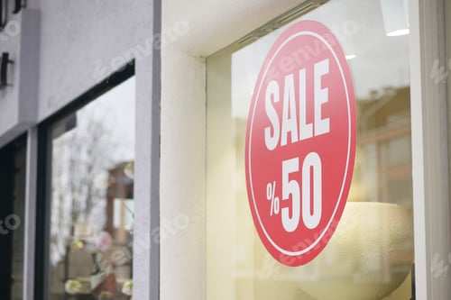 Preview: Sale sign displaying fifty percent discount in retail store