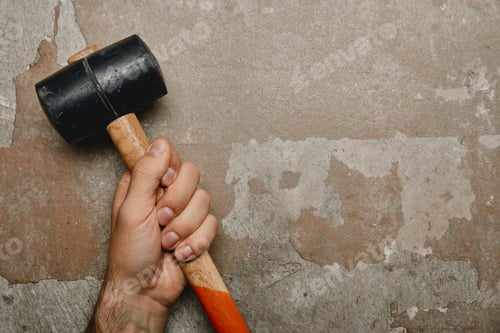 Preview: Partial view of man holding mallet on old background